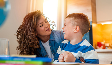 mother and son sharing a joyful moment while laughing together during indoor activity celebrating 15 memorable moments